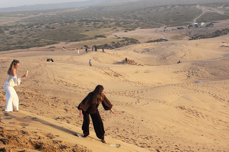 Sandboarding experience in Taghazout dunes at sunset