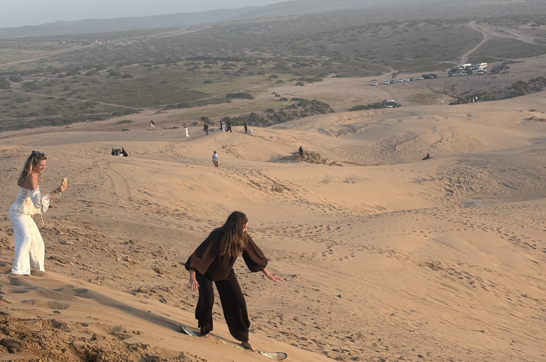 Sandboarding near Agadir in the Timlalin Dunes at sunset
