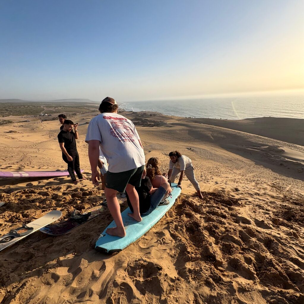 Sandboarding near Taghazout with ocean views