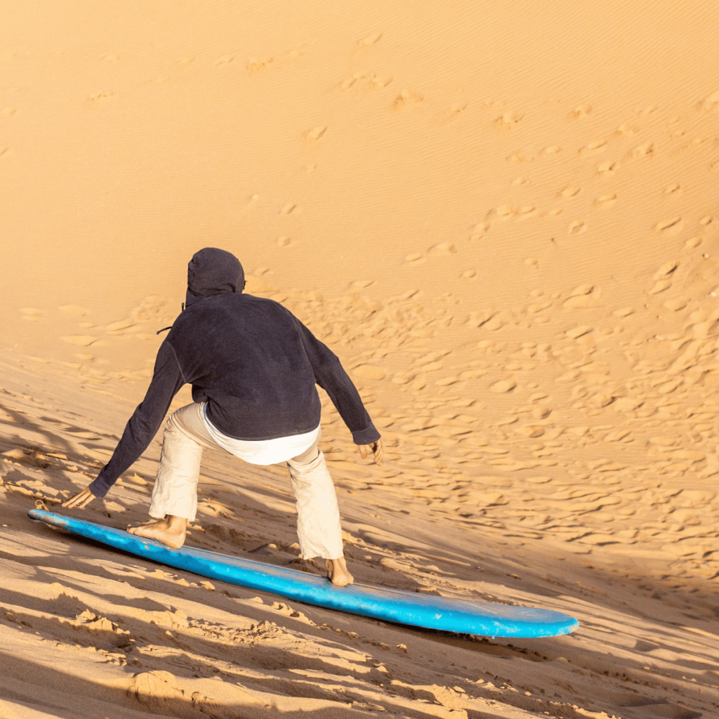 Light layers and closed shoes are perfect for a sunset sandboarding trip near Taghazout