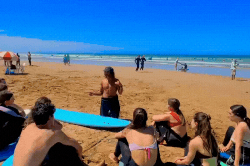 Beginner surf lesson in Taghazout Morocco with local instructor and small group, showing standalone lesson booking without surf camp accommodation